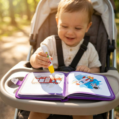 Transportation — toddler painting the book on a stroller tray in the park
